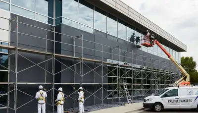 Professional commercial painters in Bakersfield CA applying durable exterior business paint finish