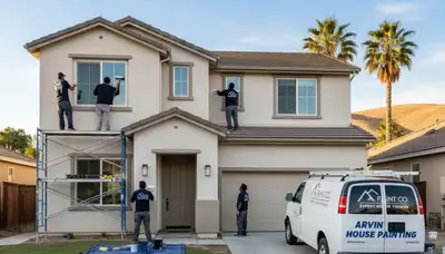 Professional house painters applying exterior paint on home in Bakersfield, CA